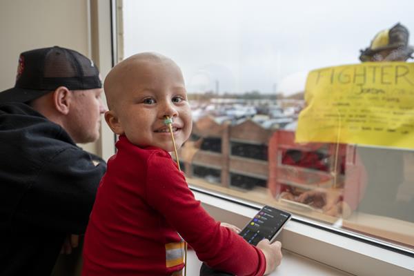 Four-year-old cancer patient Nolan Turner had a visit from Norfolk and Portsmouth firefighters who used fire truck ladders to greet him through his 5th floor window at Children's Hospital of The King's Daughters in Norfolk.
Photo: Ken Mountain
