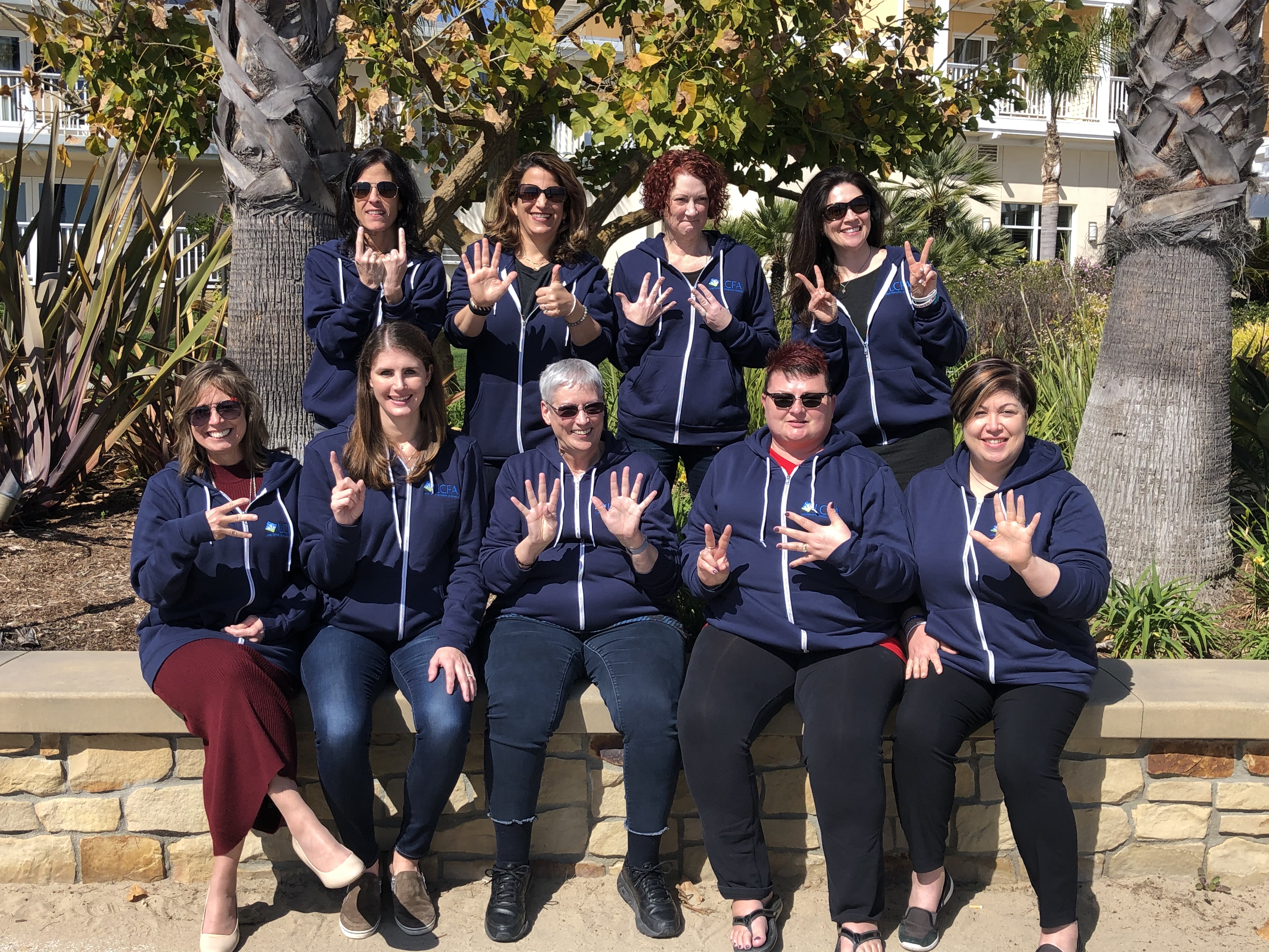 Members of Lung Cancer Foundation of America's Speakers Bureau hold up fingers to represent how many years they've been living with lung cancer.