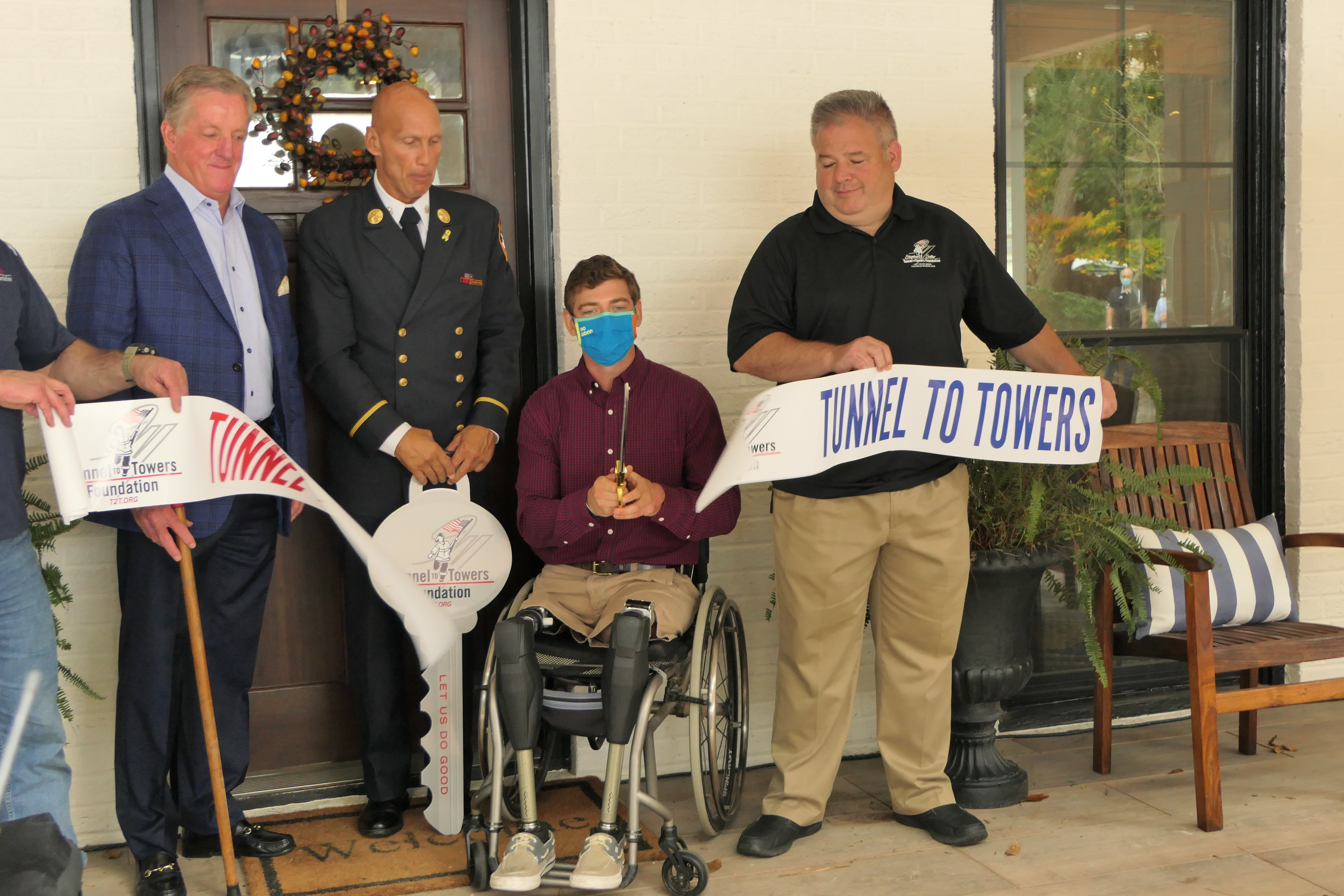 U.S. Army Captain Dan Berschinski cuts a ceremonial ribbon outside of his Atlanta home. 