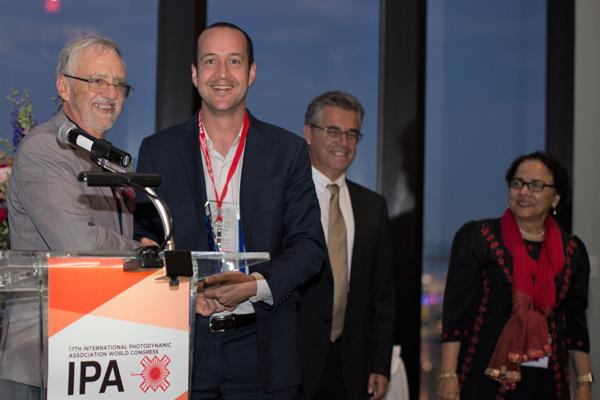 Dr. Jonathan Lovell (second from the left) receiving the 2019 Basic PDT Research Excellence Award from Dr. Brian Wilson (left), IPA President, Dr. Luis Arnaut (second from the right), and IPA Past-President, Dr. Tayyaba Hassan (right).
