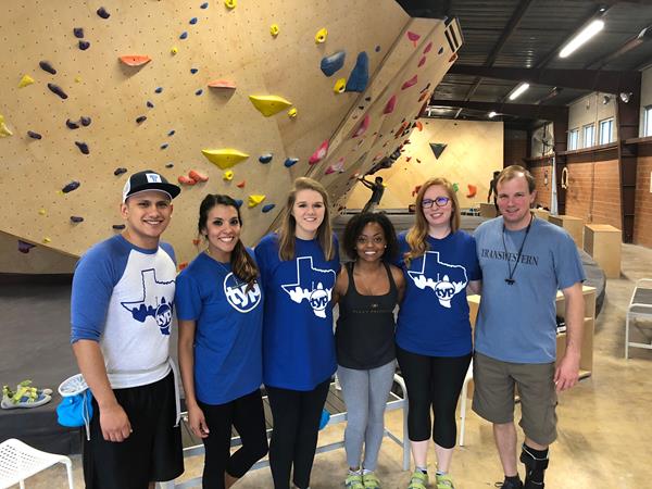 Young professionals from Transwestern’s San Antonio office show their strength at a company-sponsored rock climbing event to promote team building and collaboration. 