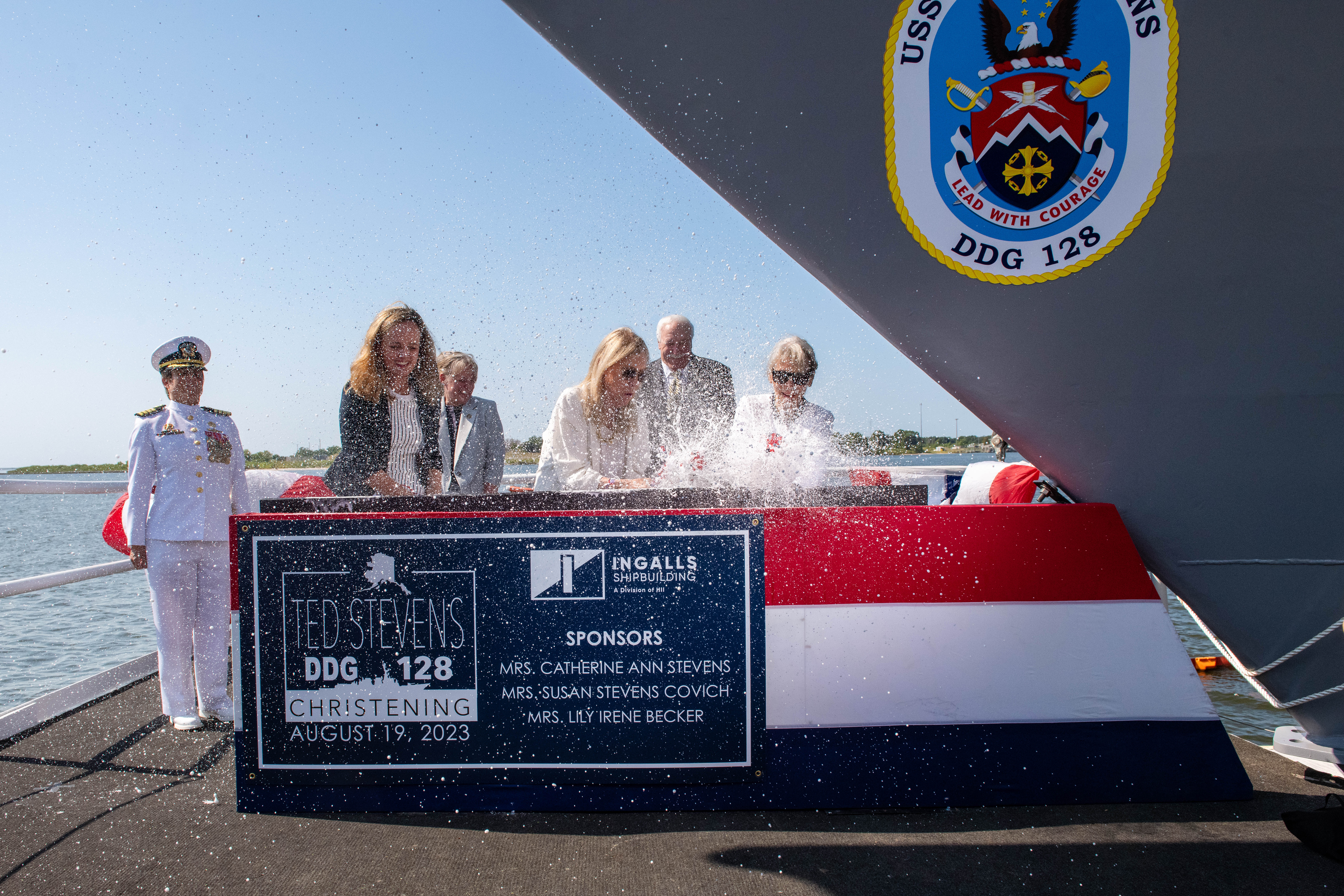 Ingalls Shipbuilding President Kari Wilkinson, DDG 128 Prospective Commanding Officer Capt. Mary Katey Hayes and Sean O'Keefe watch as ship co-sponsors officially christen Arleigh Burke-class destroyer Ted Stevens (DDG 128).