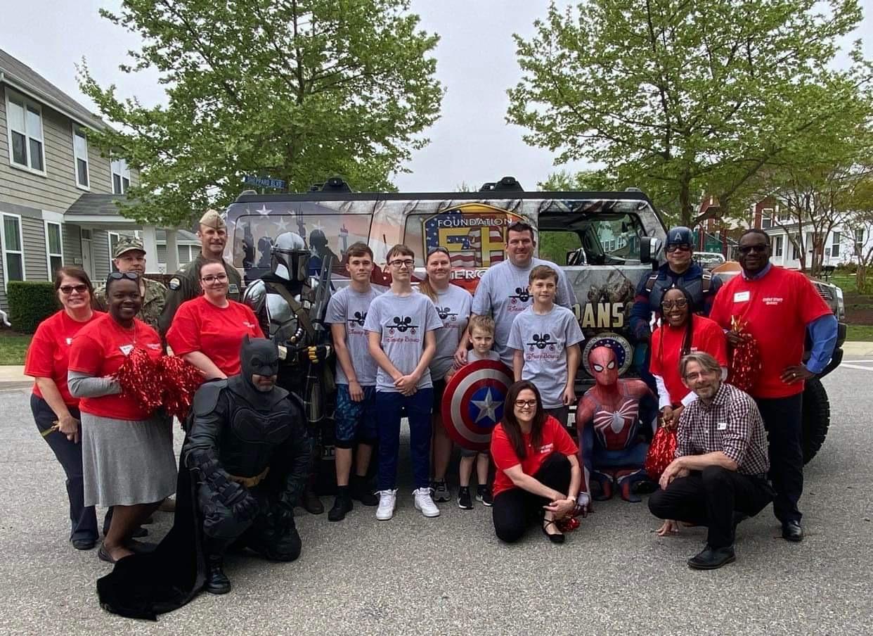 Max and his family with local heroes