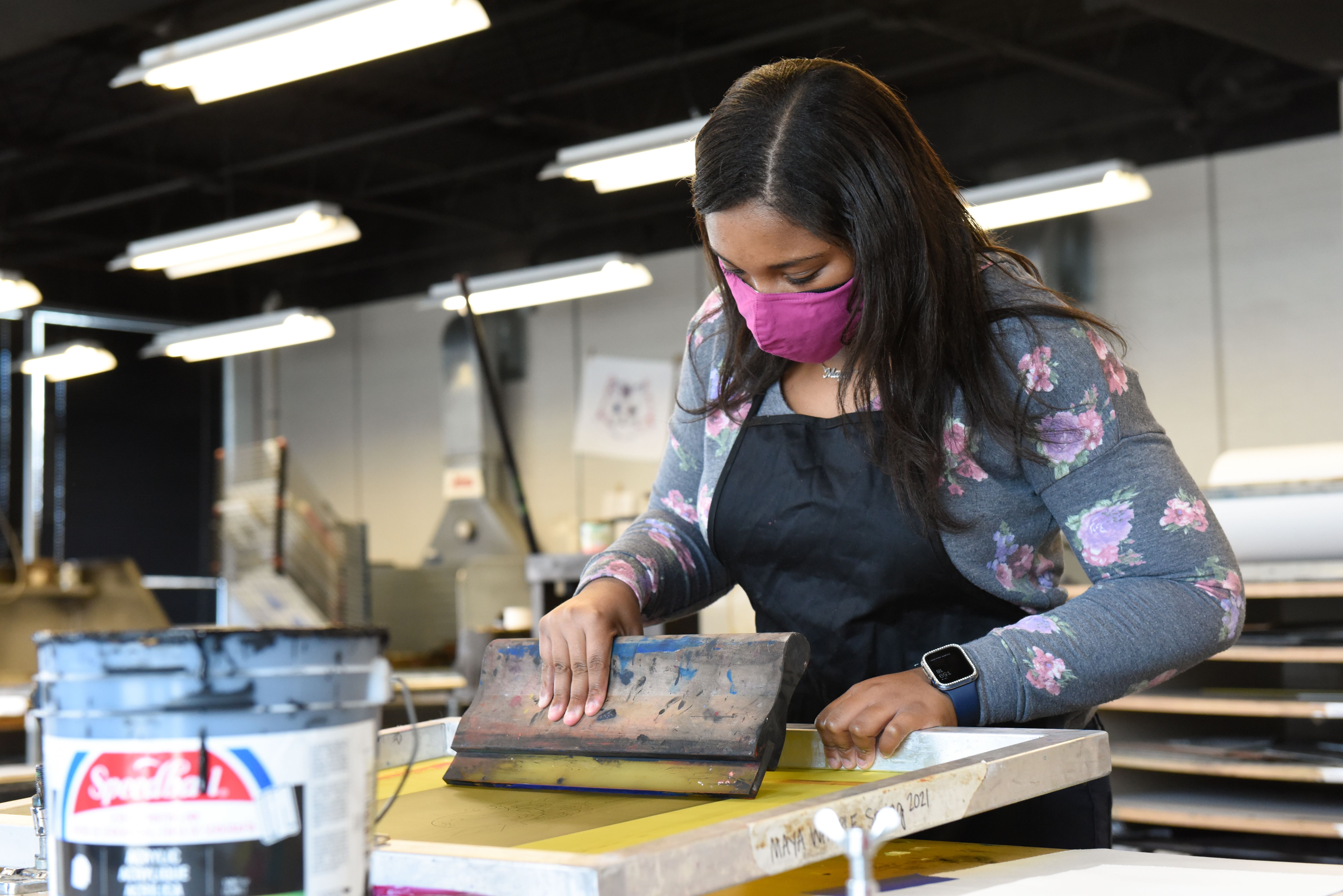 Georgia College Studio Art Major Maya Whipple of Gordon, Georgia, applies ink during printmaking.