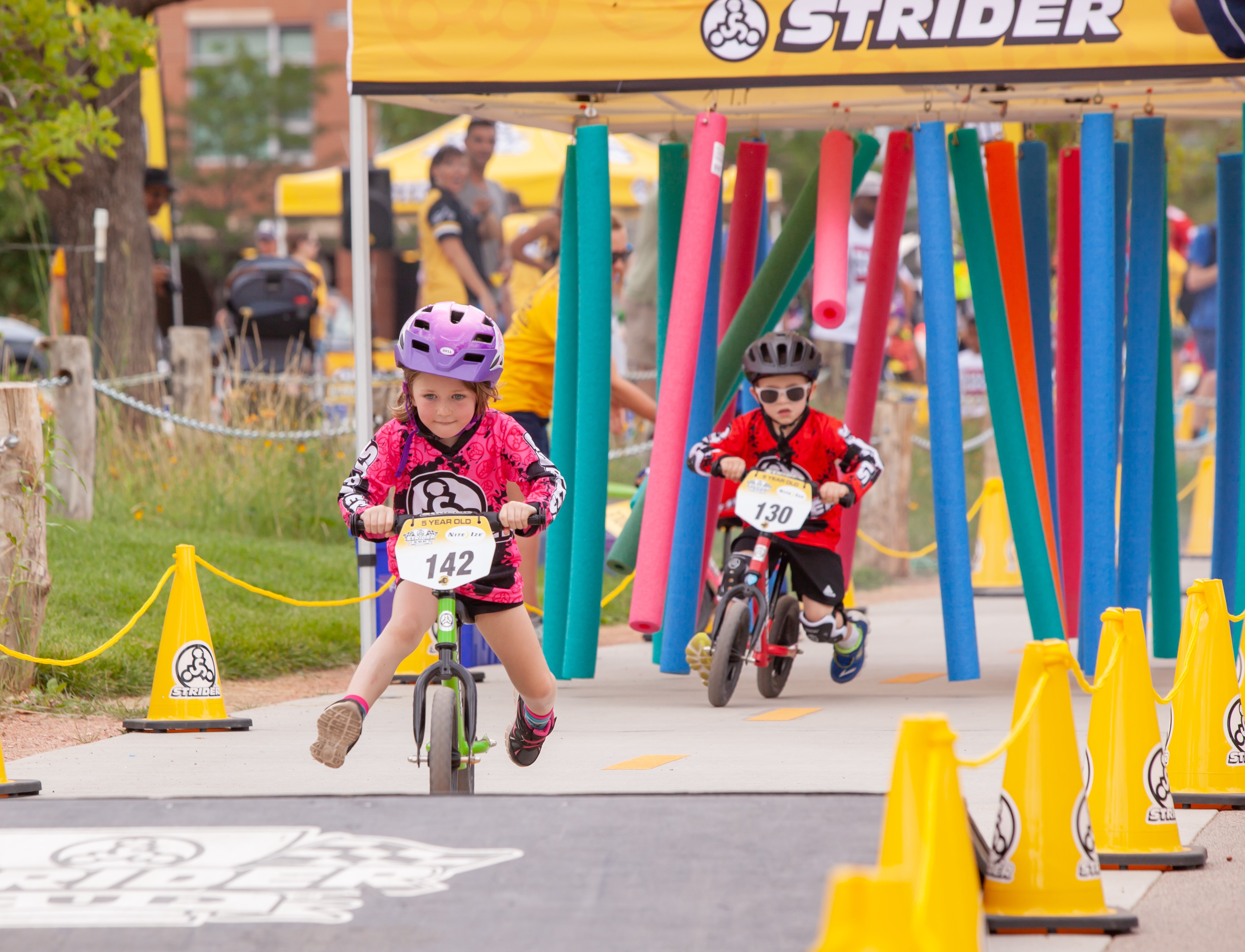 Racers dash through the "Noodle Monster" at the 2018 Strider Cup World Championship in Boulder, CO. North American races are set this year for Los Angeles, Boulder, Minneapolis, Surrey, and Charlotte. 