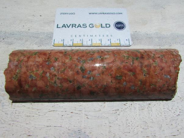 High-grade example of gold mineralization in episyenite from drill hole 23FP006. The rock consists of 95% brick red potassium feldspar and whitish pink albite, 1-2% black to dark green iron-rich chlorite, 1-2% grey and white carbonate vesicles, and 3-4% disseminated to network textured pyrite and arsenian pyrite. This example is from drill hole 23FP006 from 160 to 161 metres. This interval grades 8.053 g/t gold.