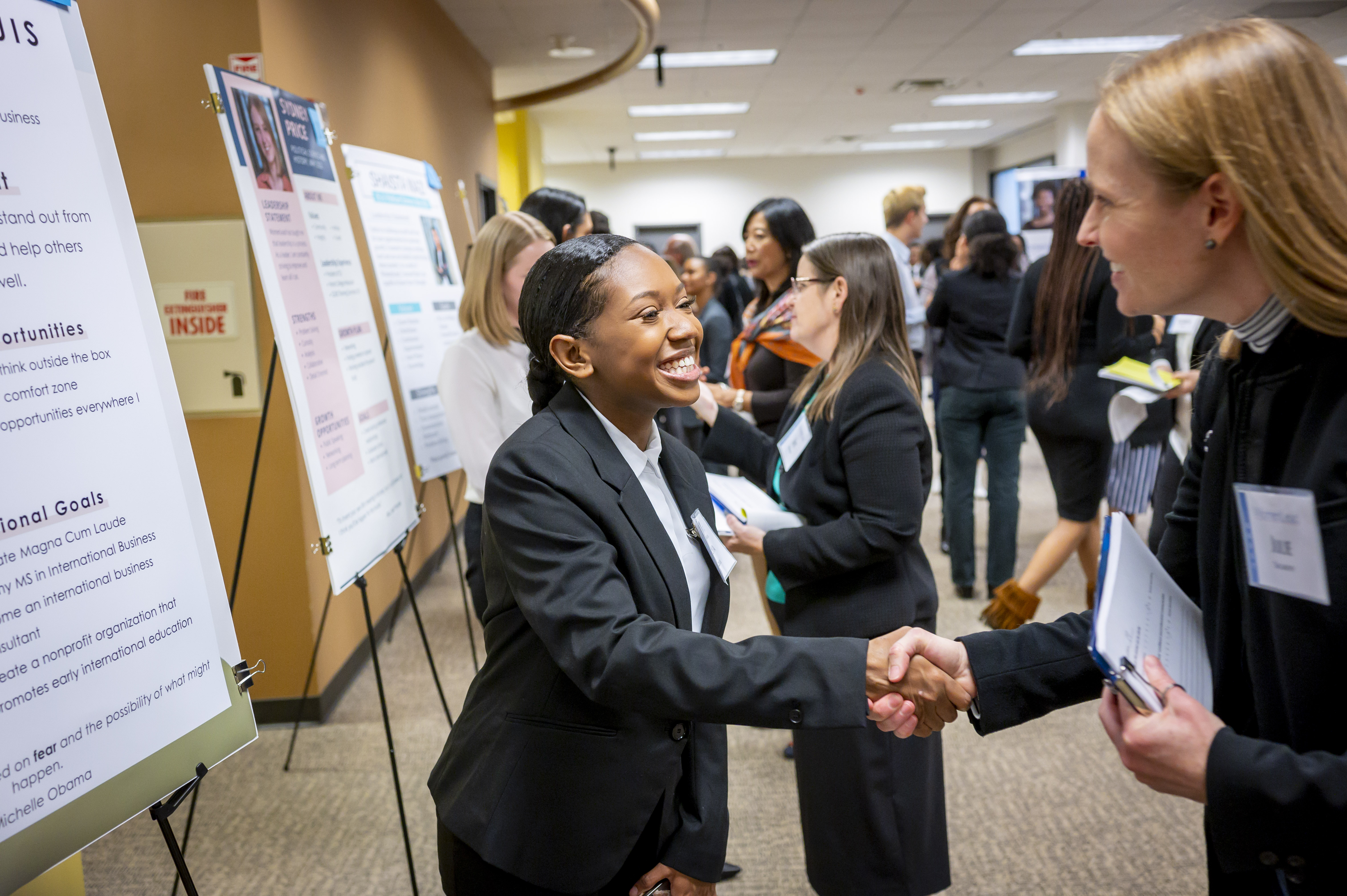 WomenLead students showcase their strategy and plans for the future during a poster presentation.