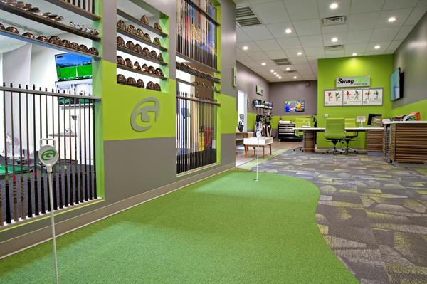 GOLFTEC lobby, putting green and club fitting wall