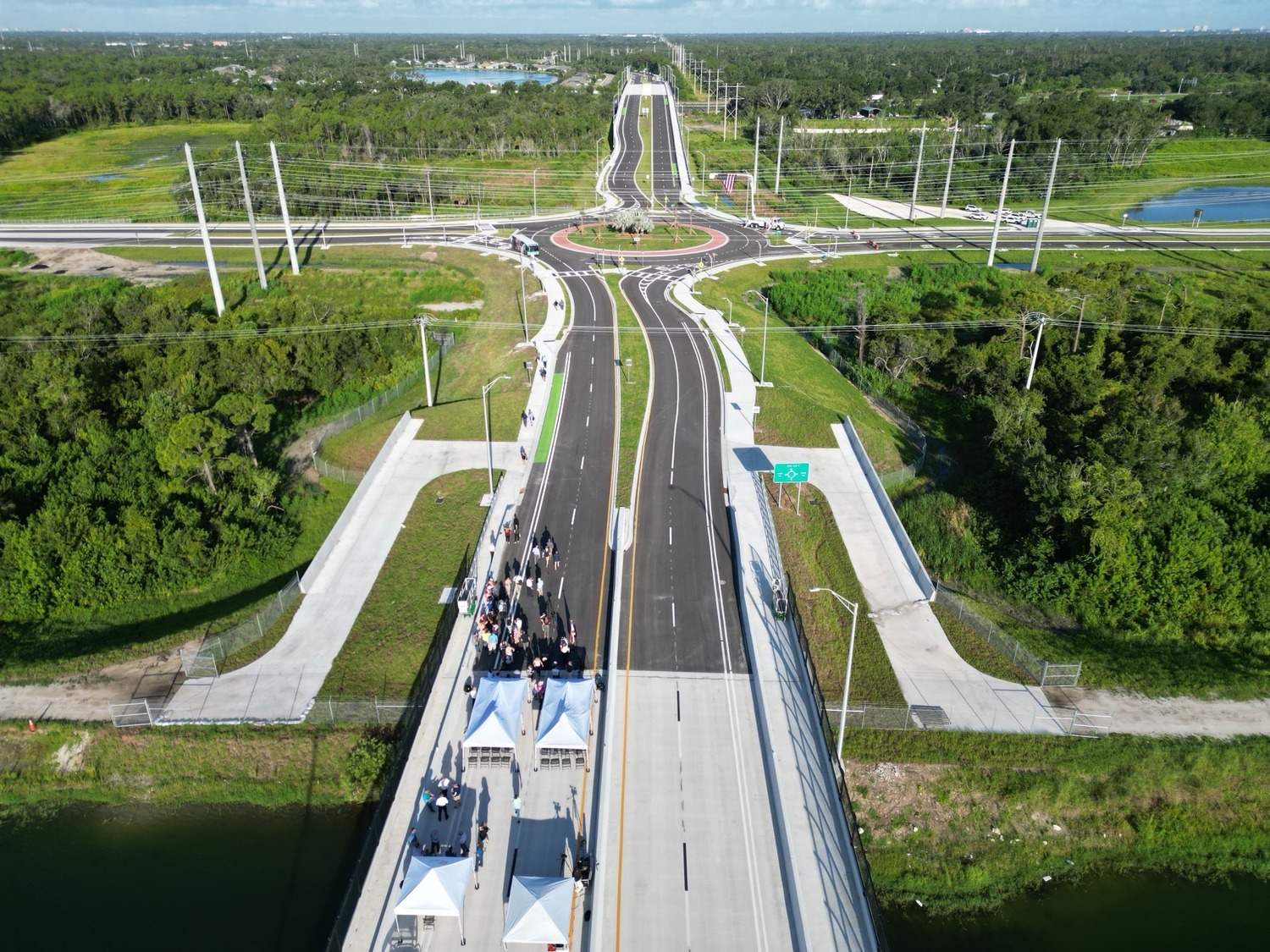 An aerial view of people standing on a road.