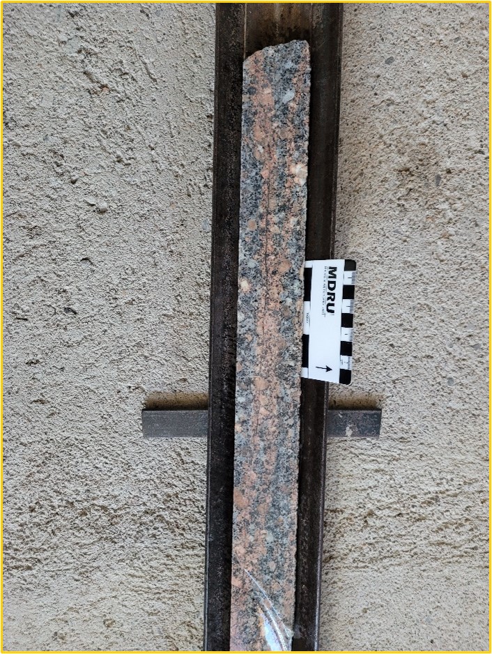 Drillhole 22MT038: Potassic alteration envelope surrounding millimetre-scale quartz-sulphide microfractures in relatively fresh granodiorite host rock at a depth of 172 metres.