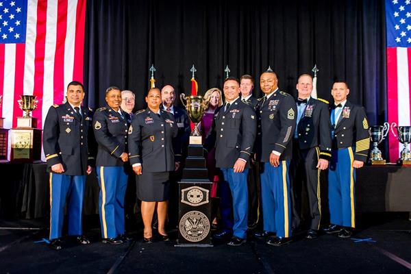 Military Foodservice Award Winners from 2019 stand on stage for national recognition and excellence in their categories.