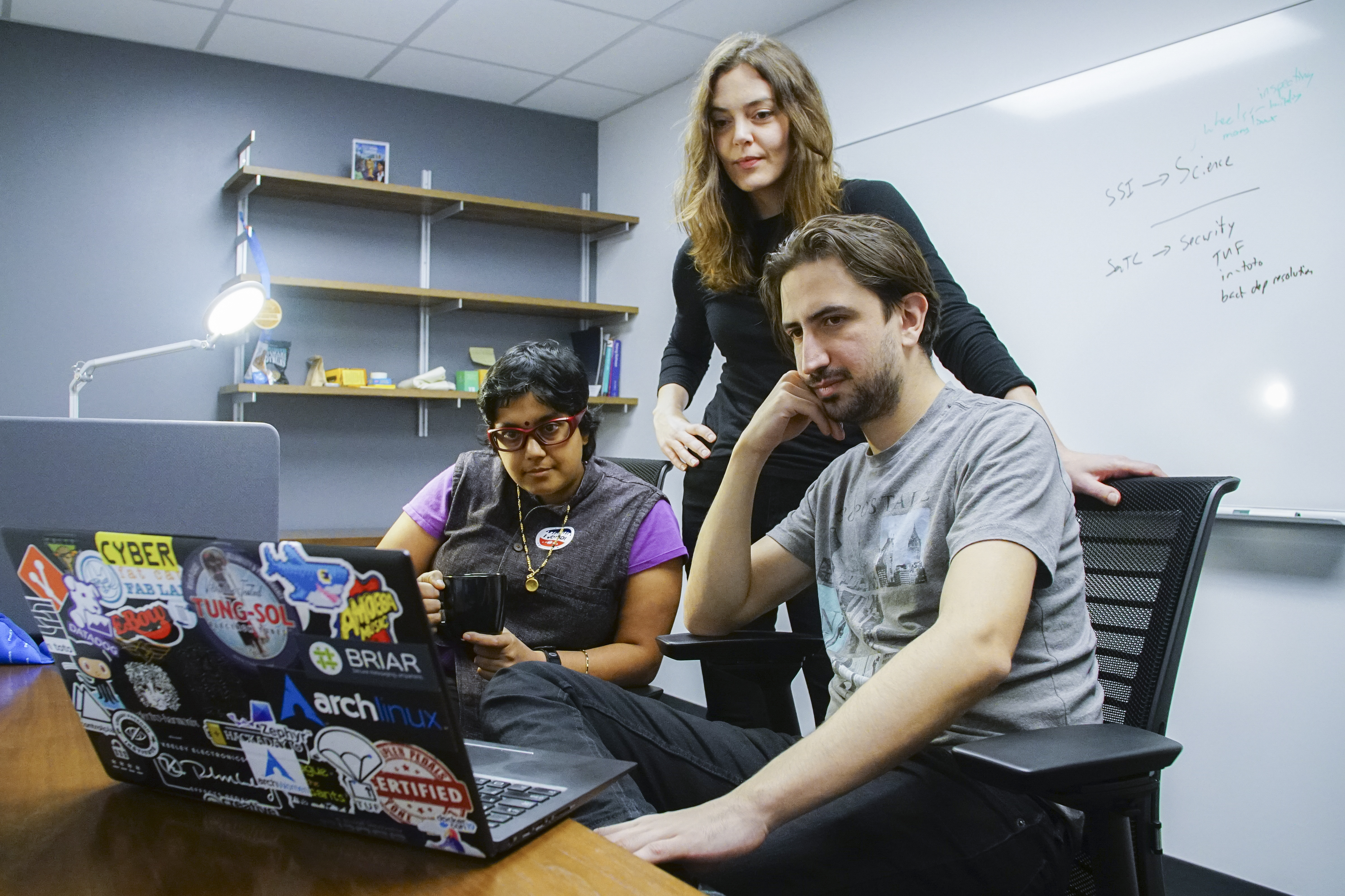 NYU Tandon and the NYU Center for Cybersecurity announced they are supplying the first office space in New York City for two of the most important open-source nonprofits in the tech world. Working at the new space in Downtown Brooklyn, left to right: Sumana Harihareswara, a volunteer with the PSF’s Packaging Working Group, a contracted project manager for the Python Packaging Index, and a visiting scholar in NYU Tandon Professor Justin Cappos's Secure Systems Lab; Stephanie Whited, communications director for the Tor Project and a visiting researcher in the Secure System Lab; and Santiago Torres, a computer science doctoral candidate working in the Secure Systems Lab. 
Photo credit: NYU Tandon: Haixin Tang