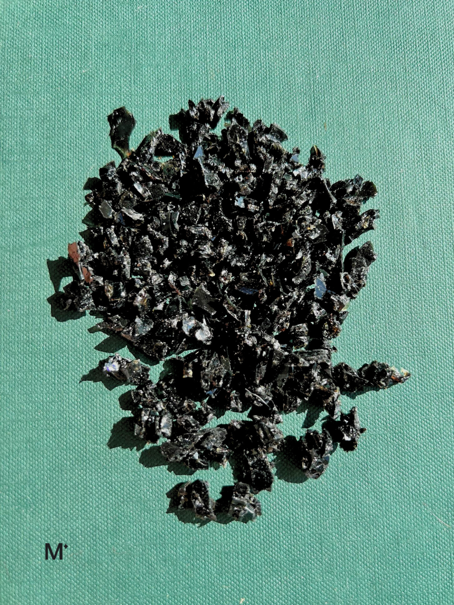 Matereal product image black chips on a green background with logo