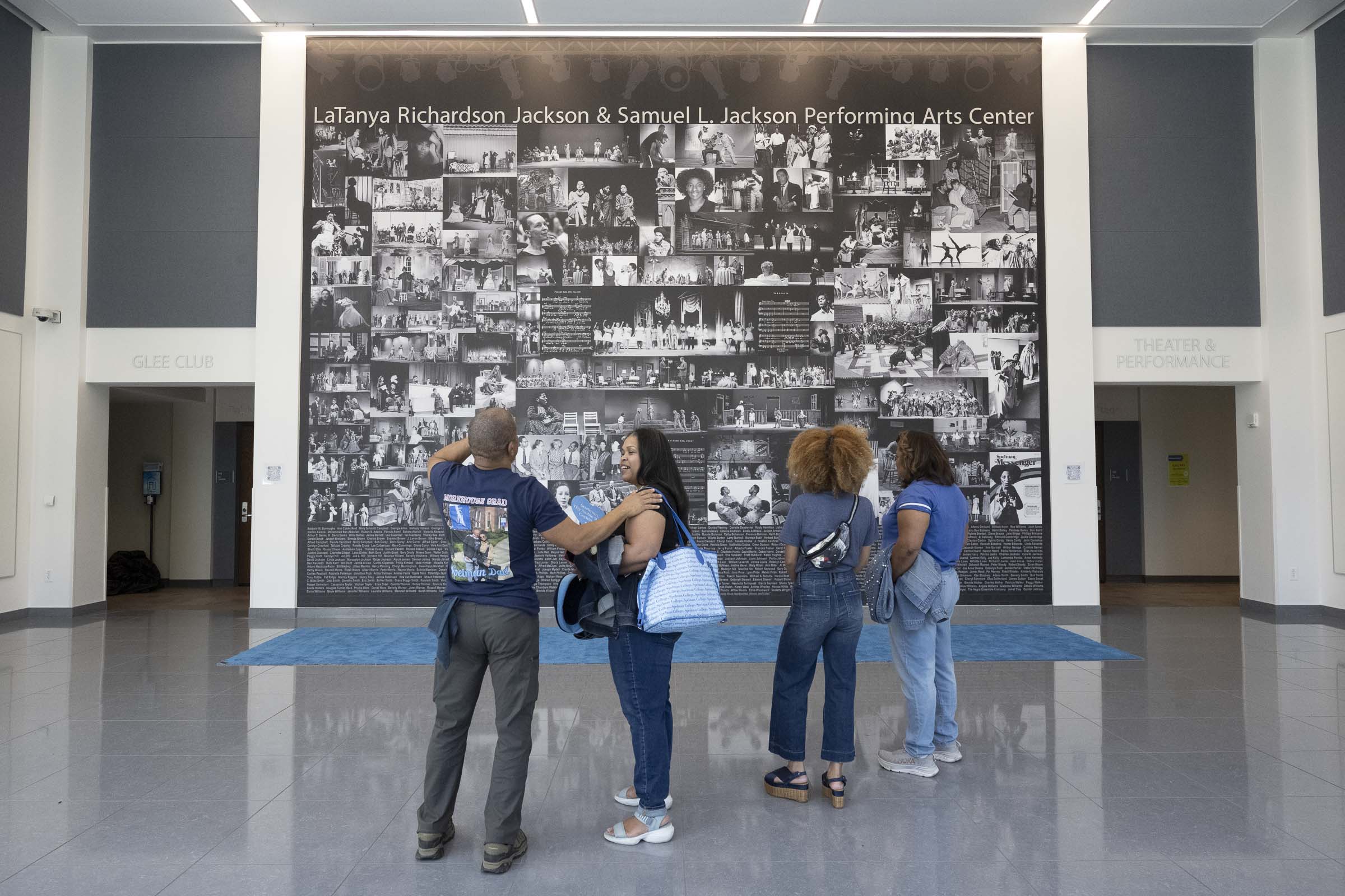 Students view the black and white mural created by Atlanta artist Quintin Jackson.