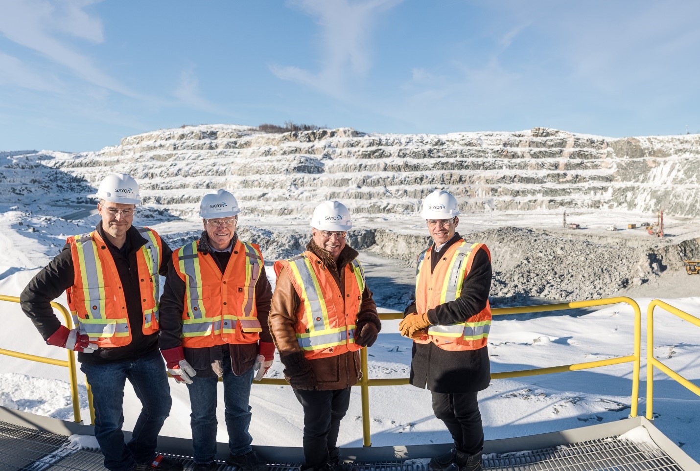 Left to right: Sylvain Collard (Sayona’s Chief Operating Officer), Brett Lynch (Sayona’s Managing Director), Stan Bharti (Jourdan’s Director) and Rene Bharti (Jourdan’s CEO) at the NAL open pit mine.