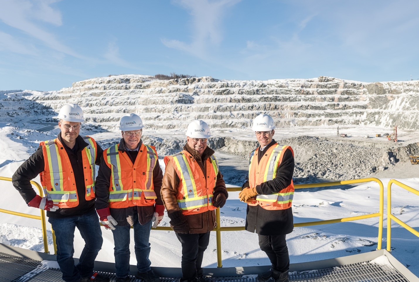 Left to right: Sylvain Collard (Sayona's Chief Operating Officer), Brett Lynch (Sayona's Managing Director), Stan Bharti (Jourdan's Director) and Rene Bharti (Jourdan's CEO) at the NAL open pit mine.