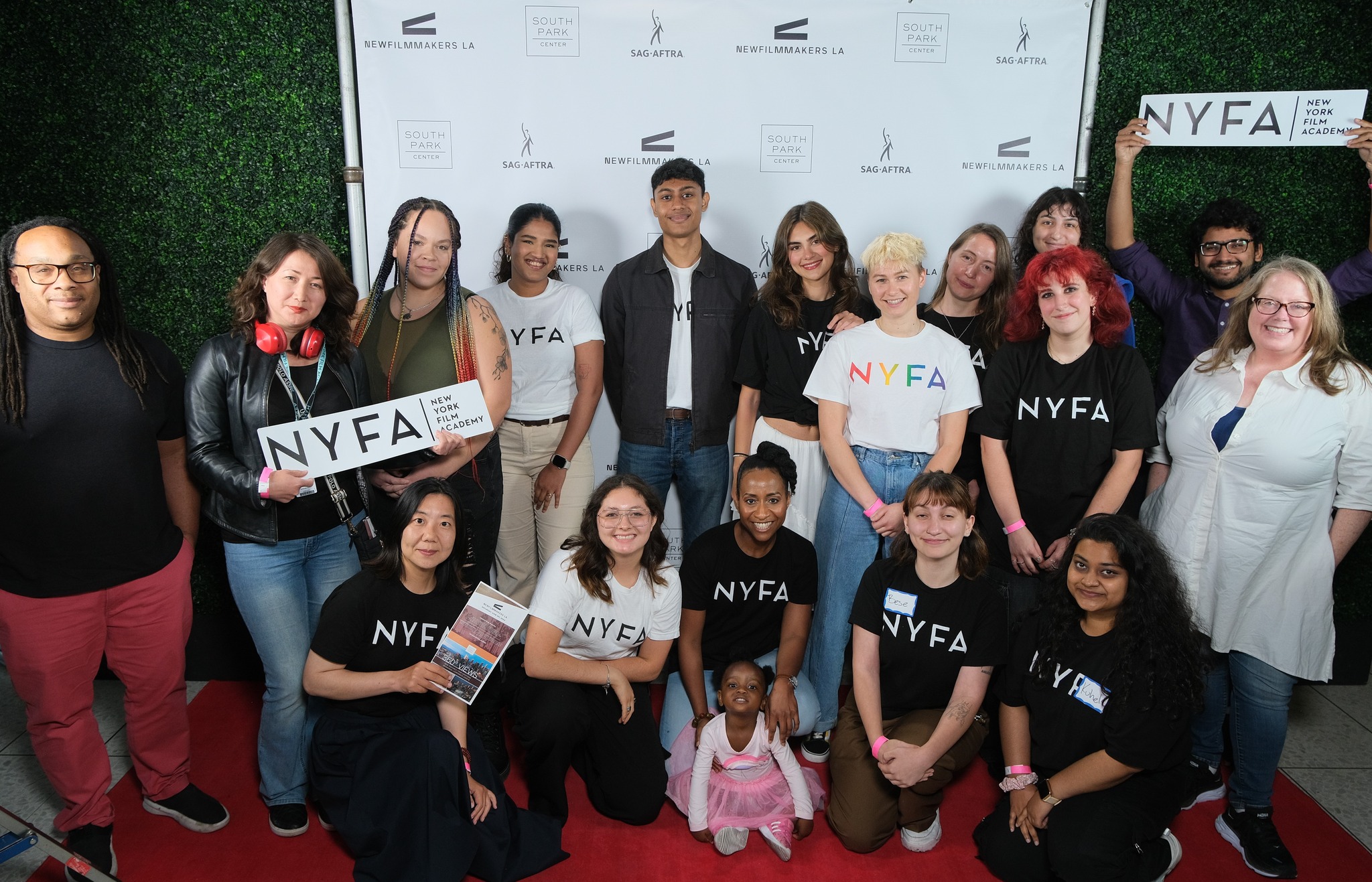 NYFA students held New York Film Academy signs and gathered around the New Filmmakers LA and SAG-AFTRA backdrop and red carpet.