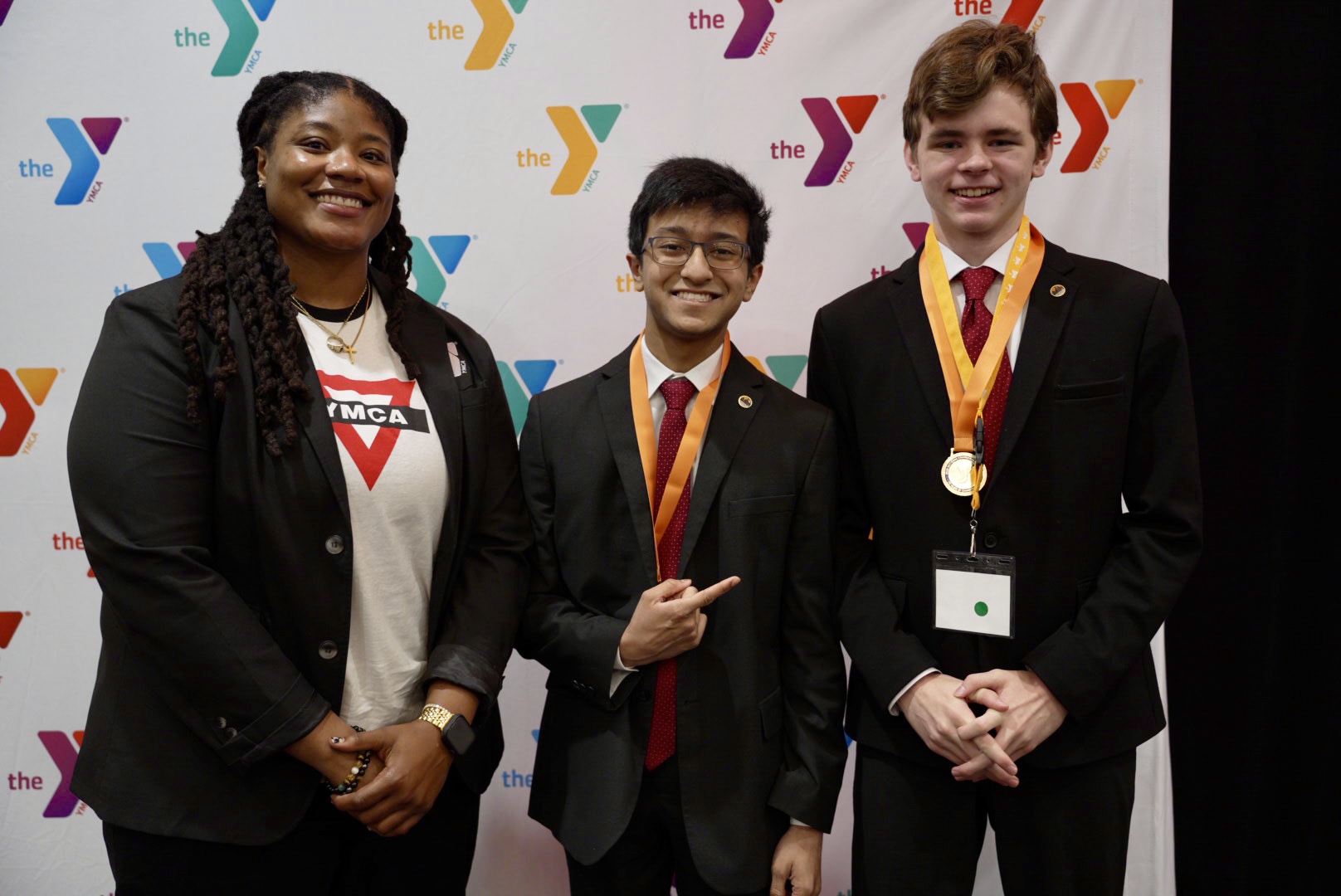 YMCA of the USA Director of Teen Strategy, E Mitchell, congratulates 2026 Changemakers Summit winners Swapneil B. and Peter H. (YMCA of Greater Housto