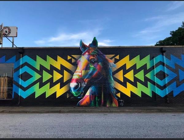 Dallas artist Michael McPheeters painted the first of 30 murals planned for the city of Decatur. “One Tribe, One Day” was unveiled in July of this year.