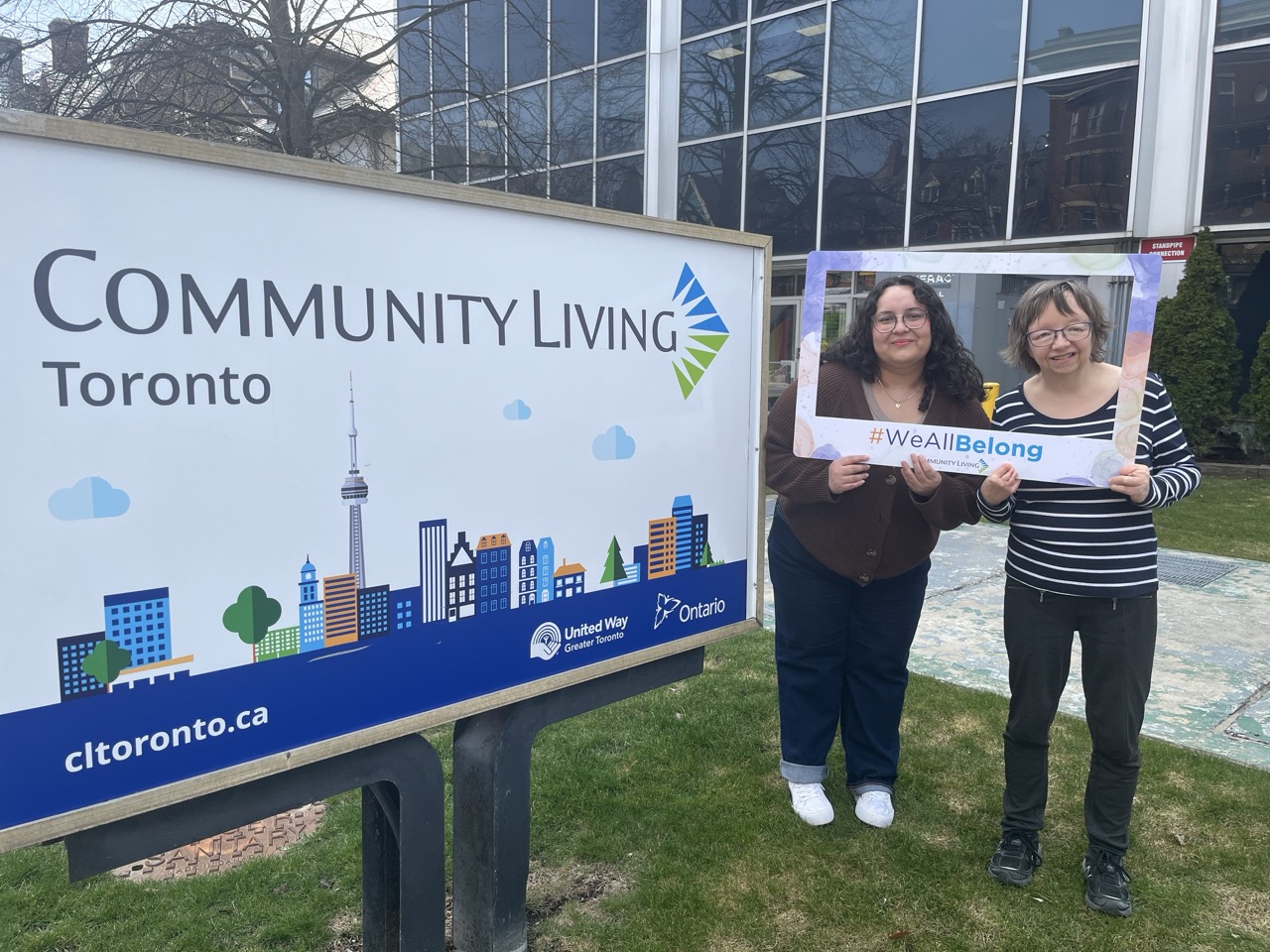 Community Living Toronto staff kick off the #WeAllBelong campaign outside one of their offices.