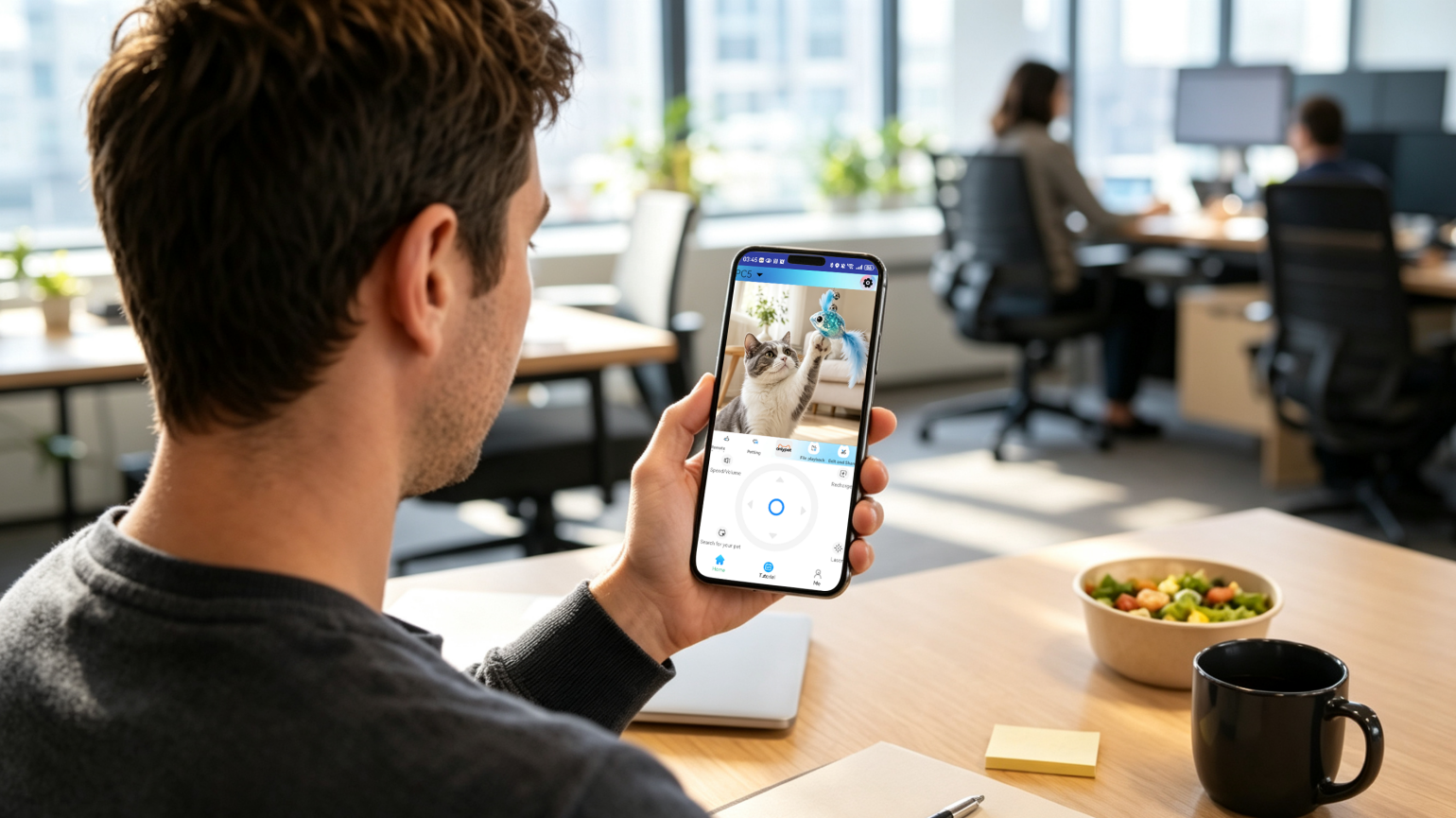 An owner uses the OnlyPet app during a work break to remotely steer the Pet Companion Robot at home.