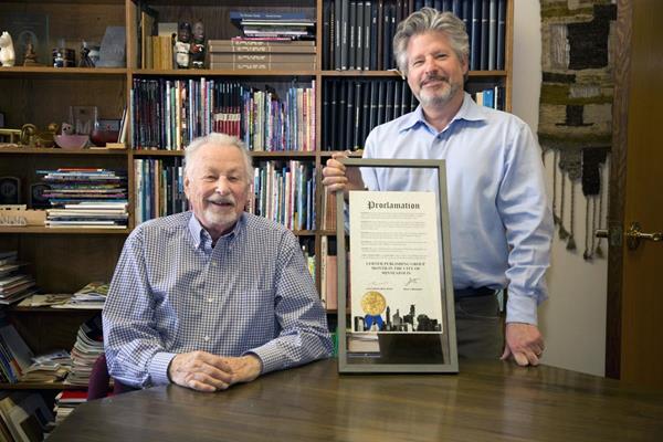 Harry Lerner (L), Founder and Chairman of the Board of Lerner Publishing Group, and Adam Lerner (R), Publisher and CEO of Lerner Publishing Group, with the Lerner Month Proclamation from the City of Minneapolis
