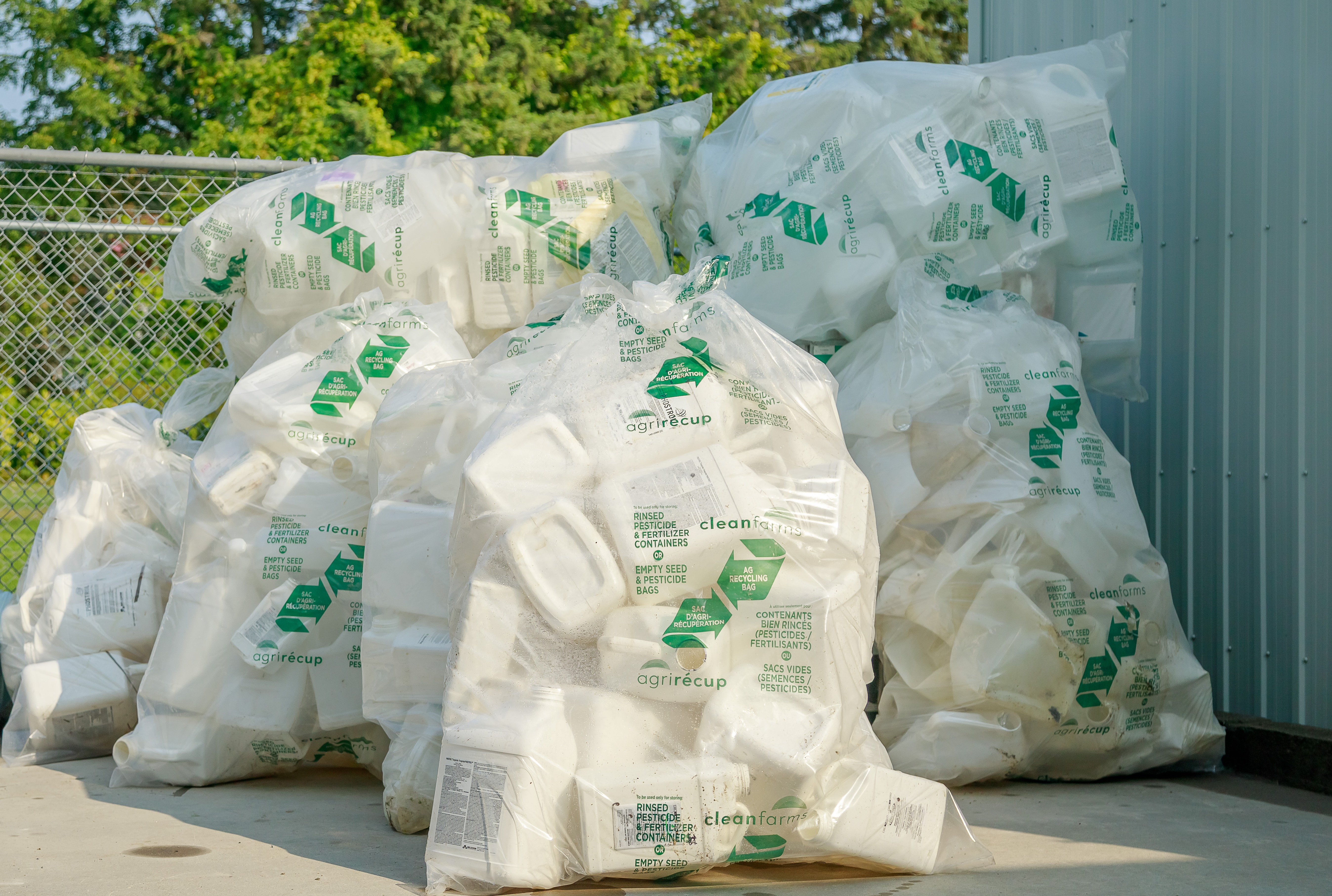 Triple-rinsed and bagged pesticide and fertilizer containers 23L and under, ready to be picked up for recycling.