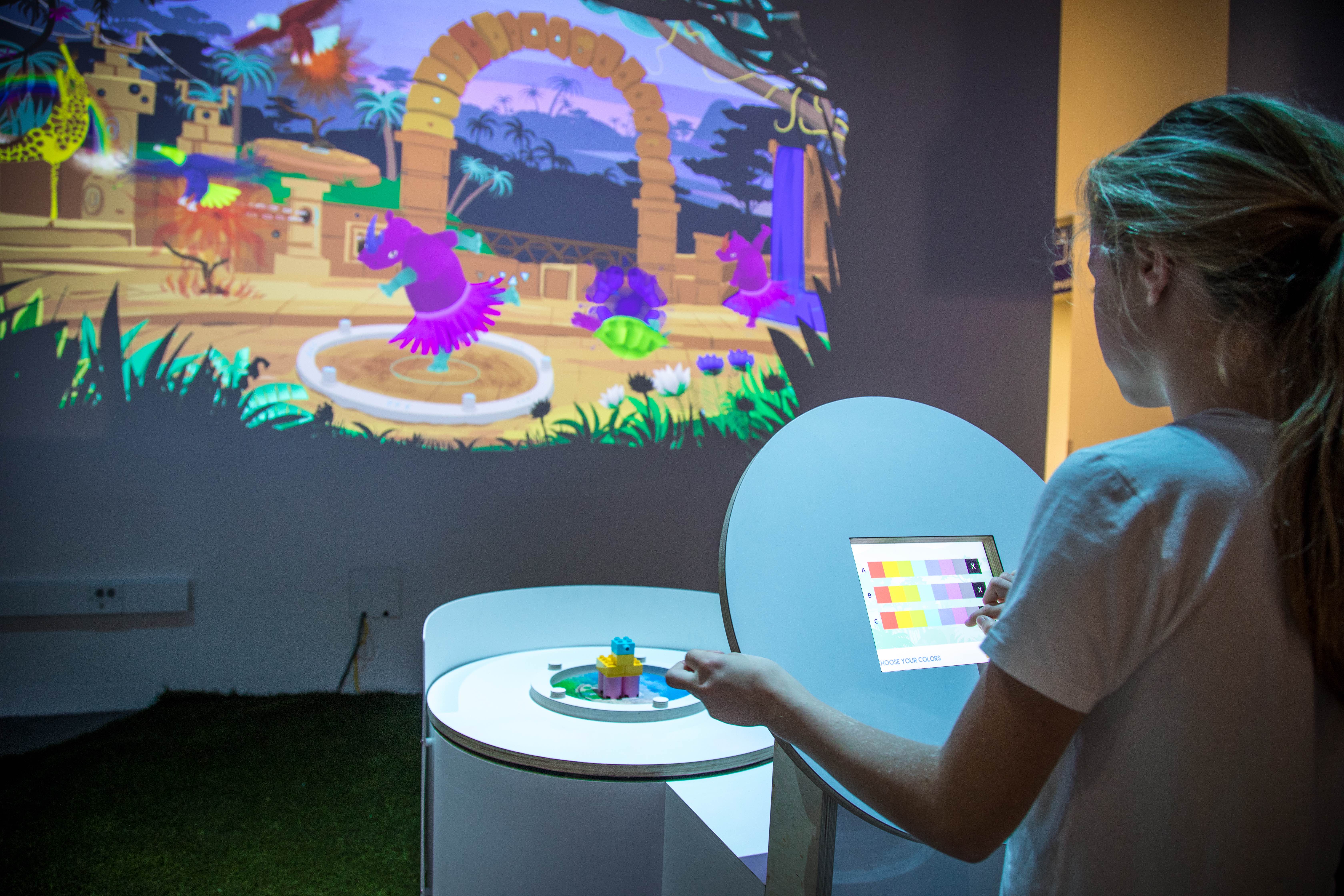 A young girl learns about Artificial Intelligence by building an animal out of blocks and challenging a robot to recognize it. Animaker is one of several creative and unique experiences exposing visitors of all ages to their ability to create with technology. You can find it at The Tech Interactive in San Jose, California.