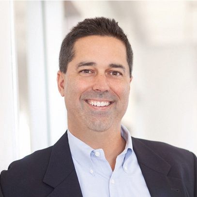 John Herr wearing a blue shirt and black suit jacket