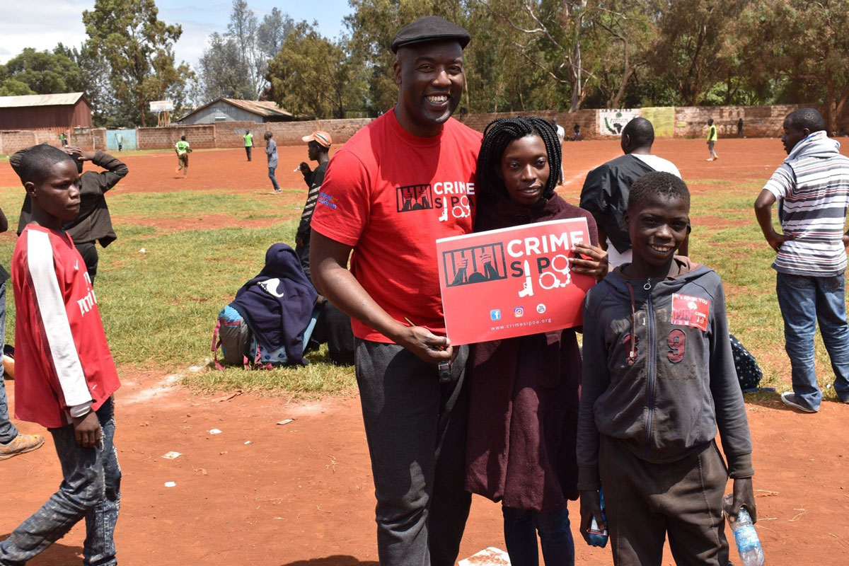 Youth Safety Awareness Initiative's Executive Director Peter Ouko with children participating in a Youth Safety Awareness Initiative program. © Youth Safety Awareness Initiative