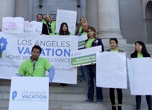 Homeowners and business owners rally at Los Angeles City Hall steps.