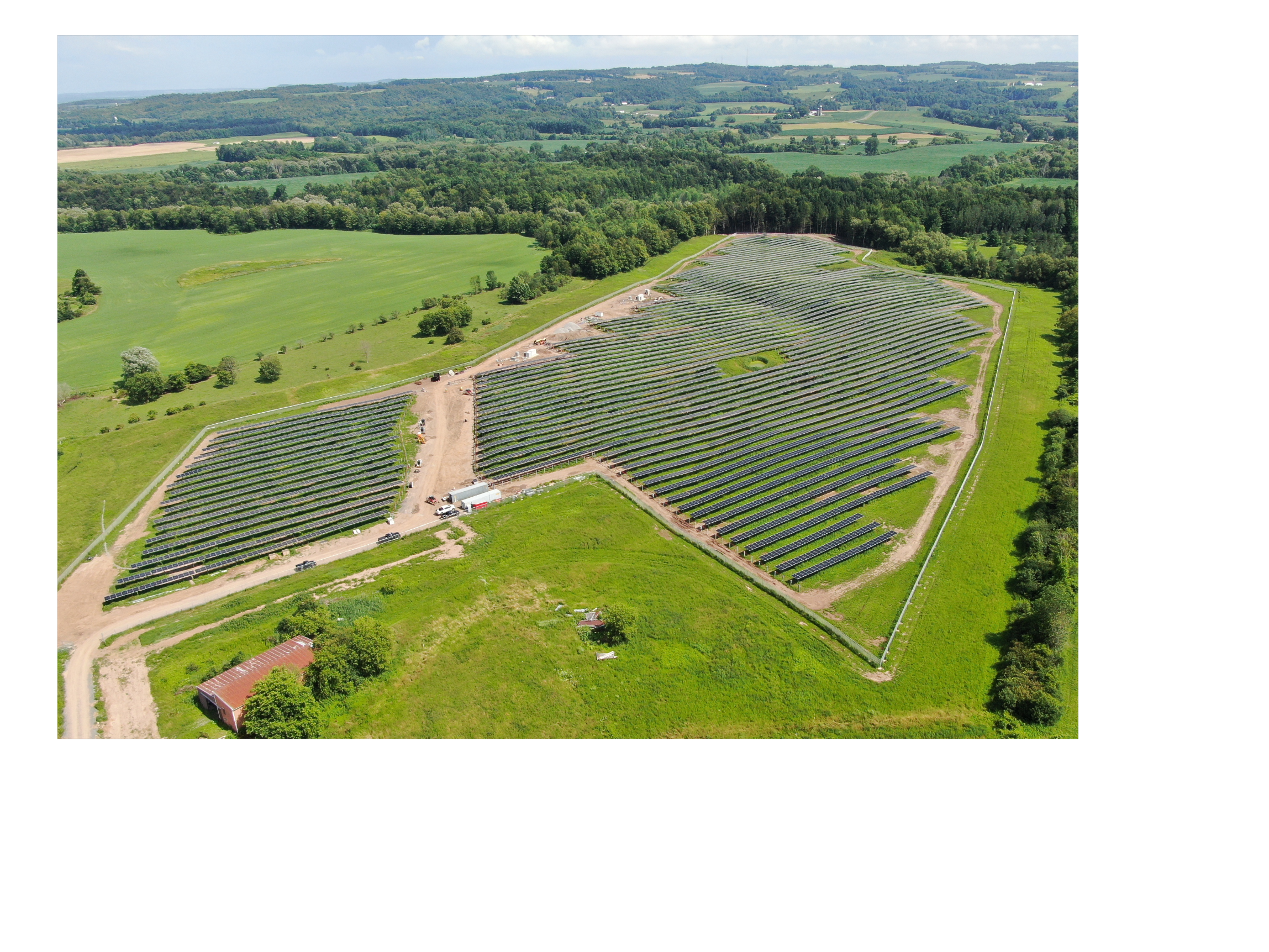 An installation of solar PV panels among hills and forest