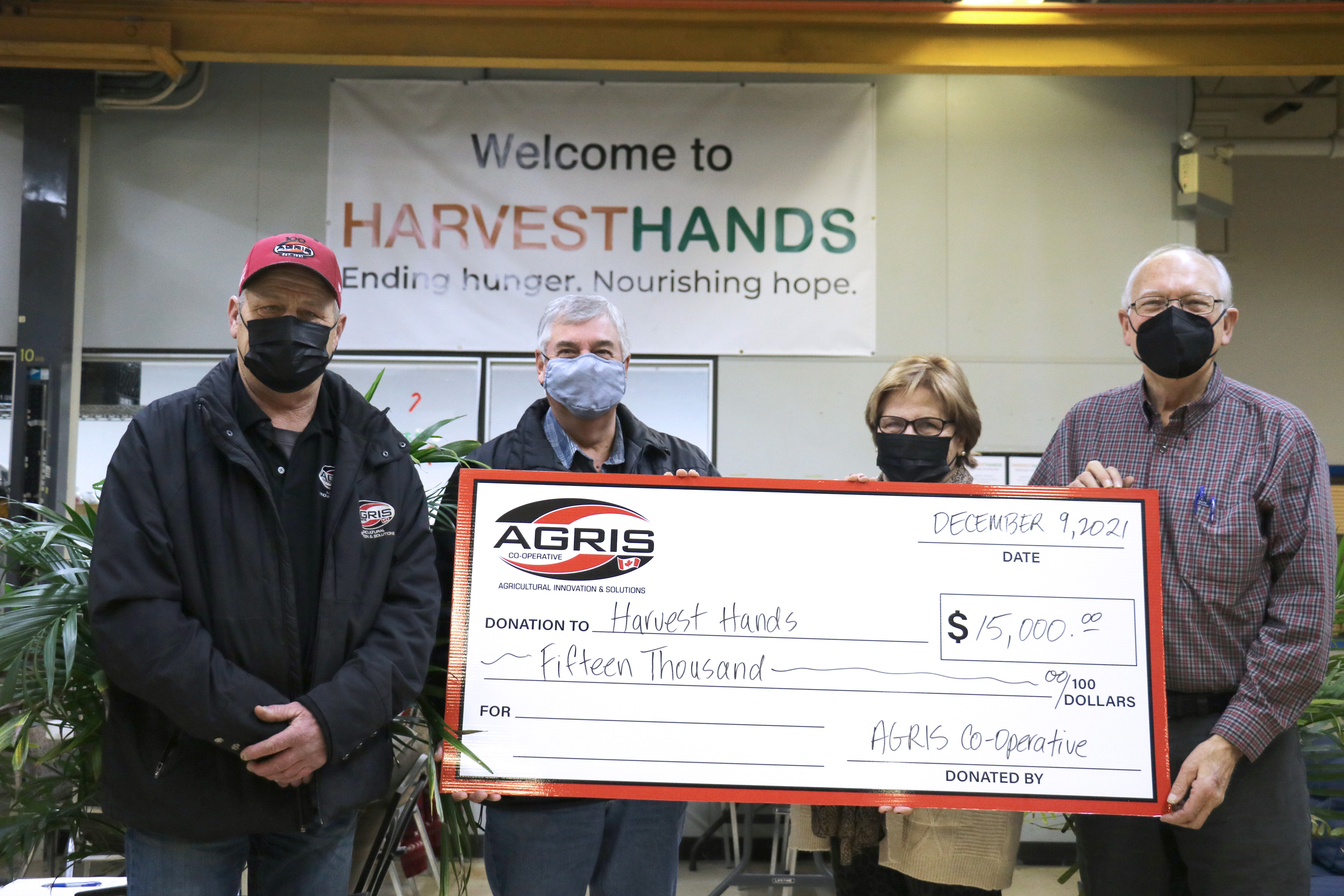 AGRIS Board members and Harvest Hands founders with oversized donation cheque.