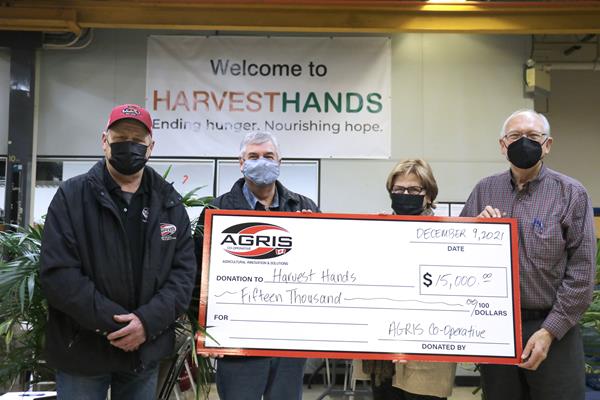 AGRIS Board members and Harvest Hands founders with oversized donation cheque.