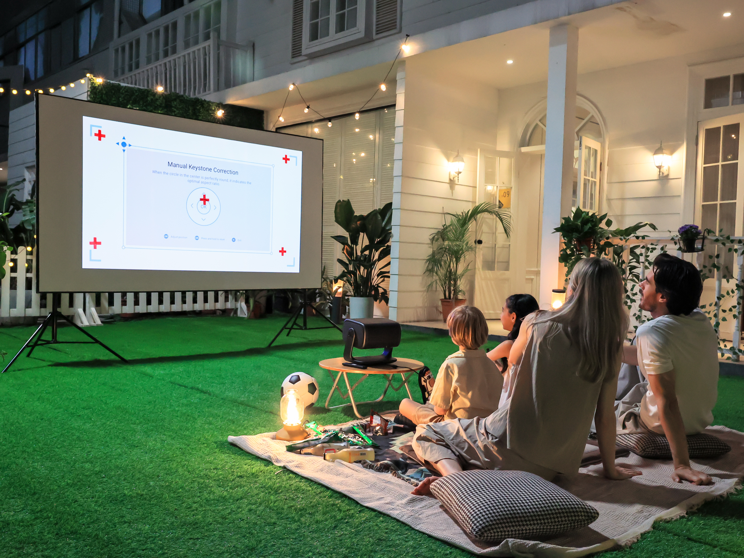 Family enjoying an outdoor movie night on a large screen with the Dangbei MP1 Max 4K laser projector — Prime Day 2026.