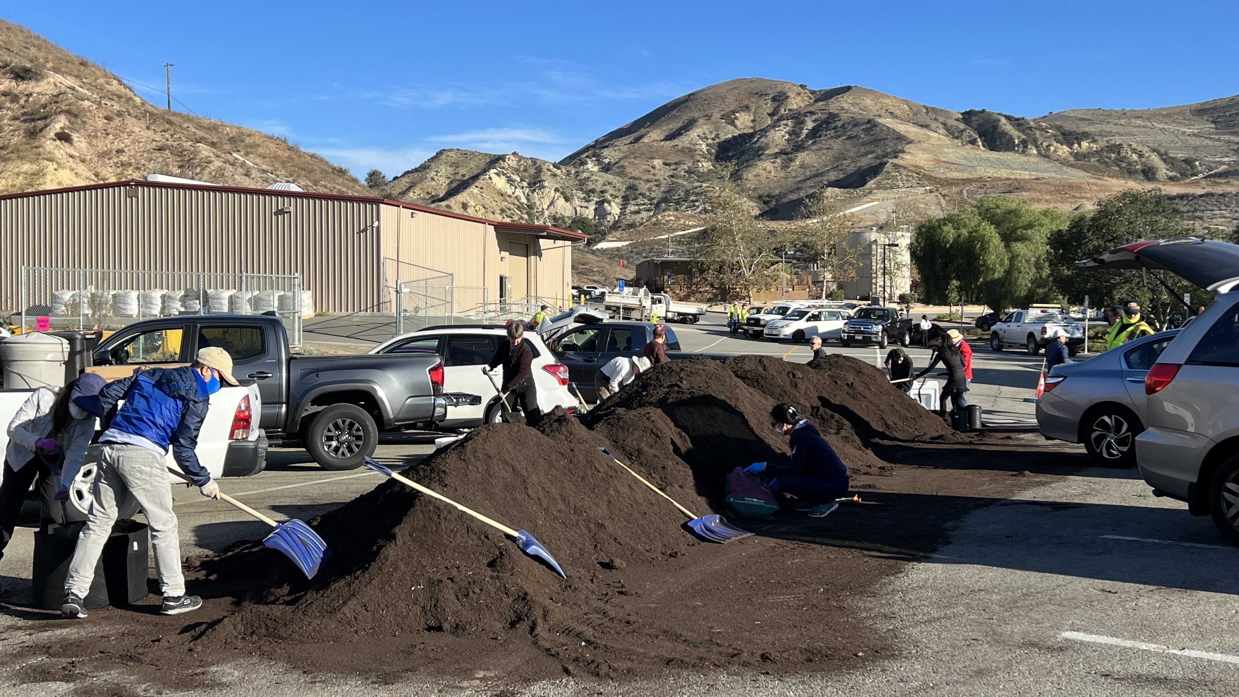 Orange County residents shoveling for their scoop of free compost.