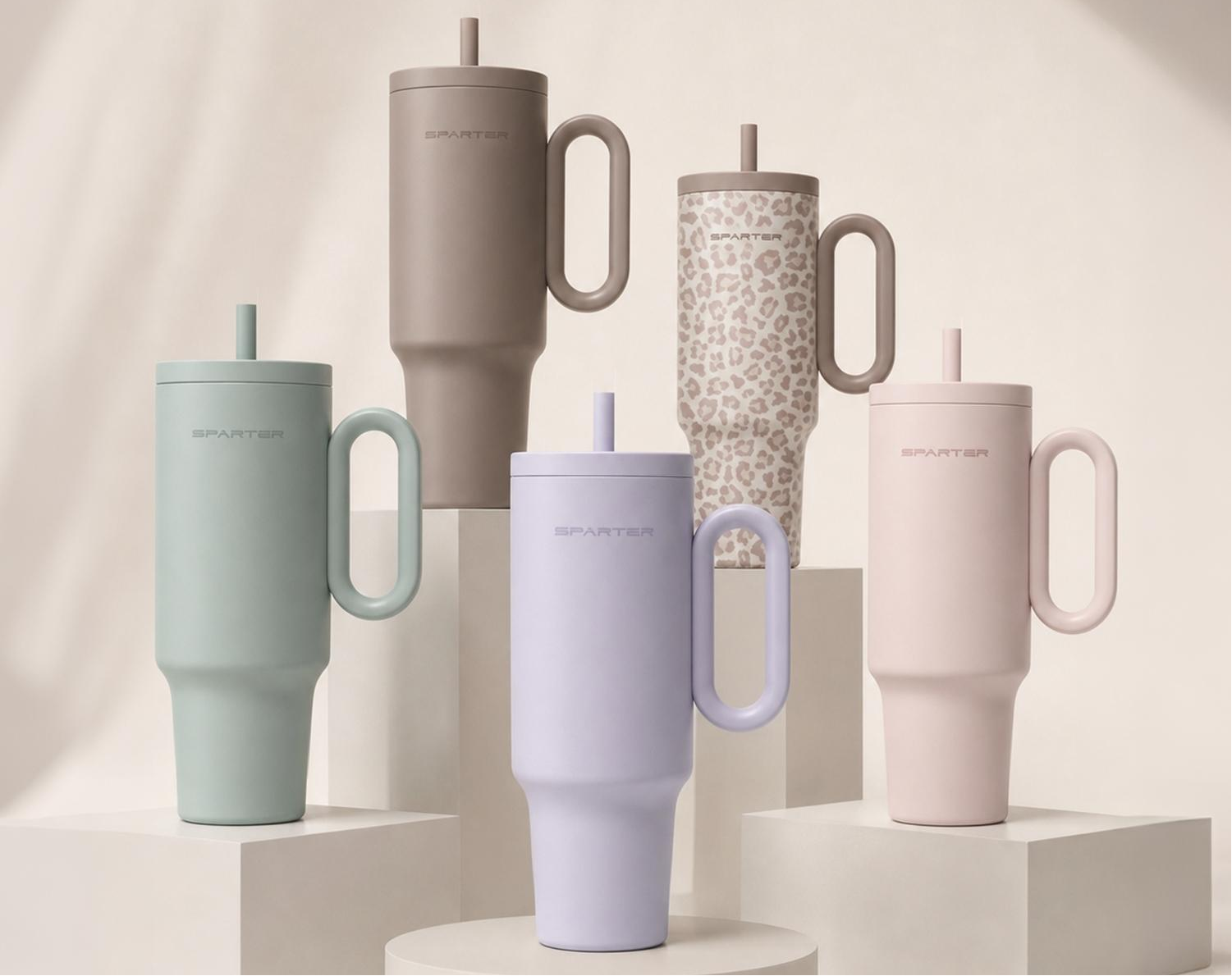 SnapSip Travel Mug collection displayed in multiple colors on modern pedestals showcasing stylish insulated tumbler designs