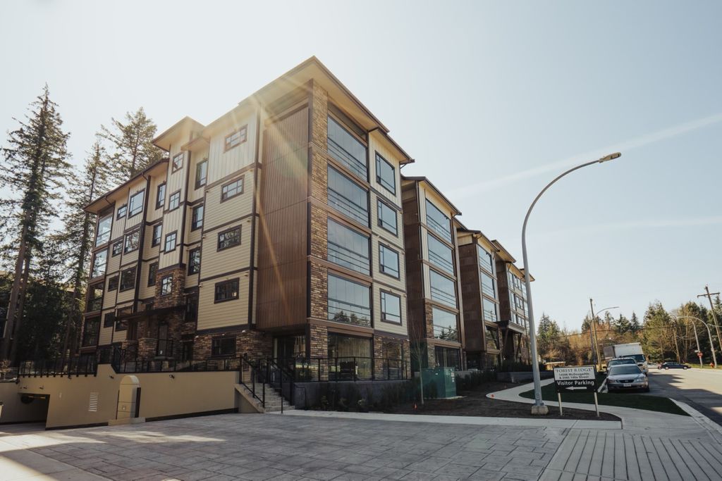 Condominium building with balconies enclosed with retractable glass