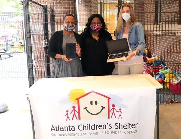 Accepting digital learning devices (left to right): Aseelah Williams, Development Coordinator, ACS; Candace Bazemore, Digital Marketing Manager, LogistiCare; 
Allison Griffith, Donor Relations Manager, ACS.