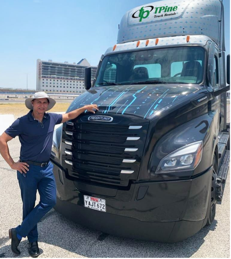 Sam Johal poses with Freightliner eCascadia