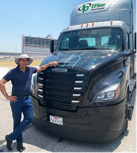 Sam Johal poses with Freightliner eCascadia