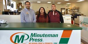 Avi Kumar (left) owns the Minuteman Press design, marketing, and printing franchise in Greeley, Colorado.