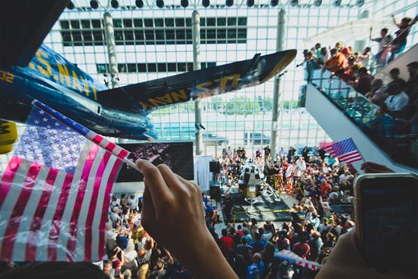 Thousands cheer with American flags as a 1/3 Scale NASA Lunar Module model descends and lands exactly at 4:17 pm from the atrium at the Cradle of Aviation Museum in Garden City, NY