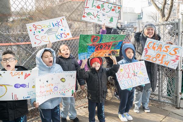 Elementary school students line the streets to cheer on seniors during the 2023 College and Career March