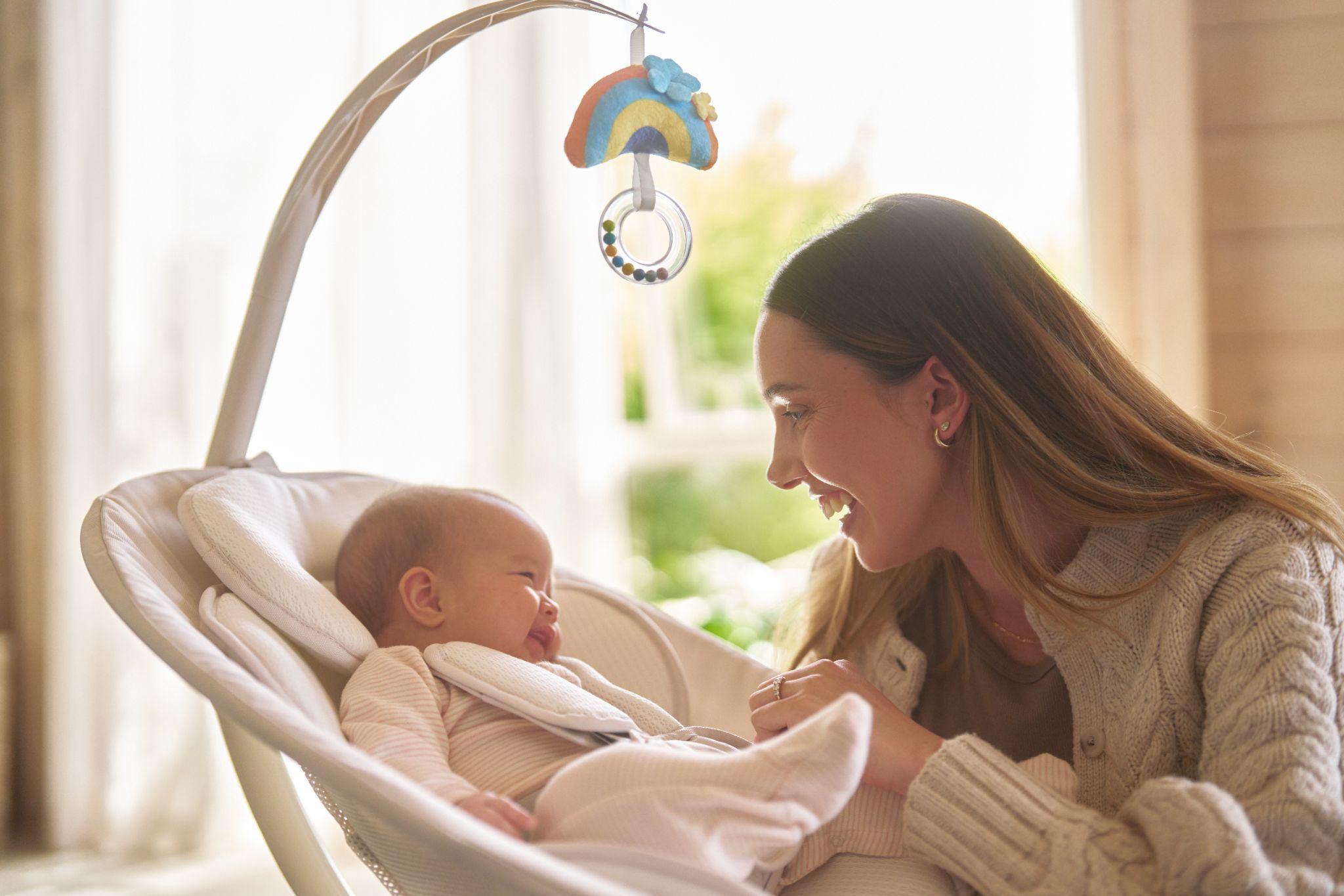Parent using GROWNSY baby swing for infants, keeping baby close and visible while enjoying hands-free time at home