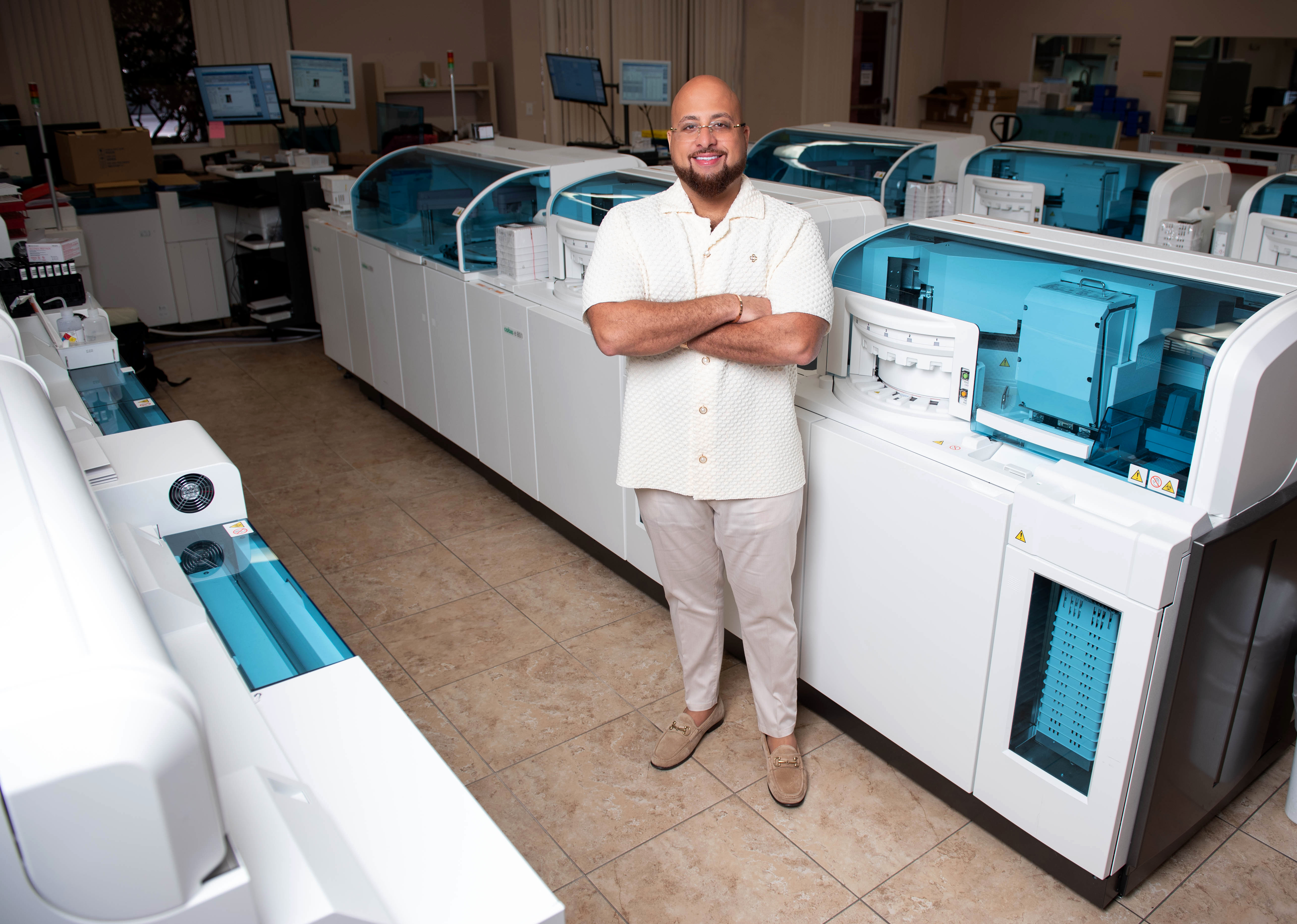 Adam El-Hosseiny with Roche Diagnostics machines