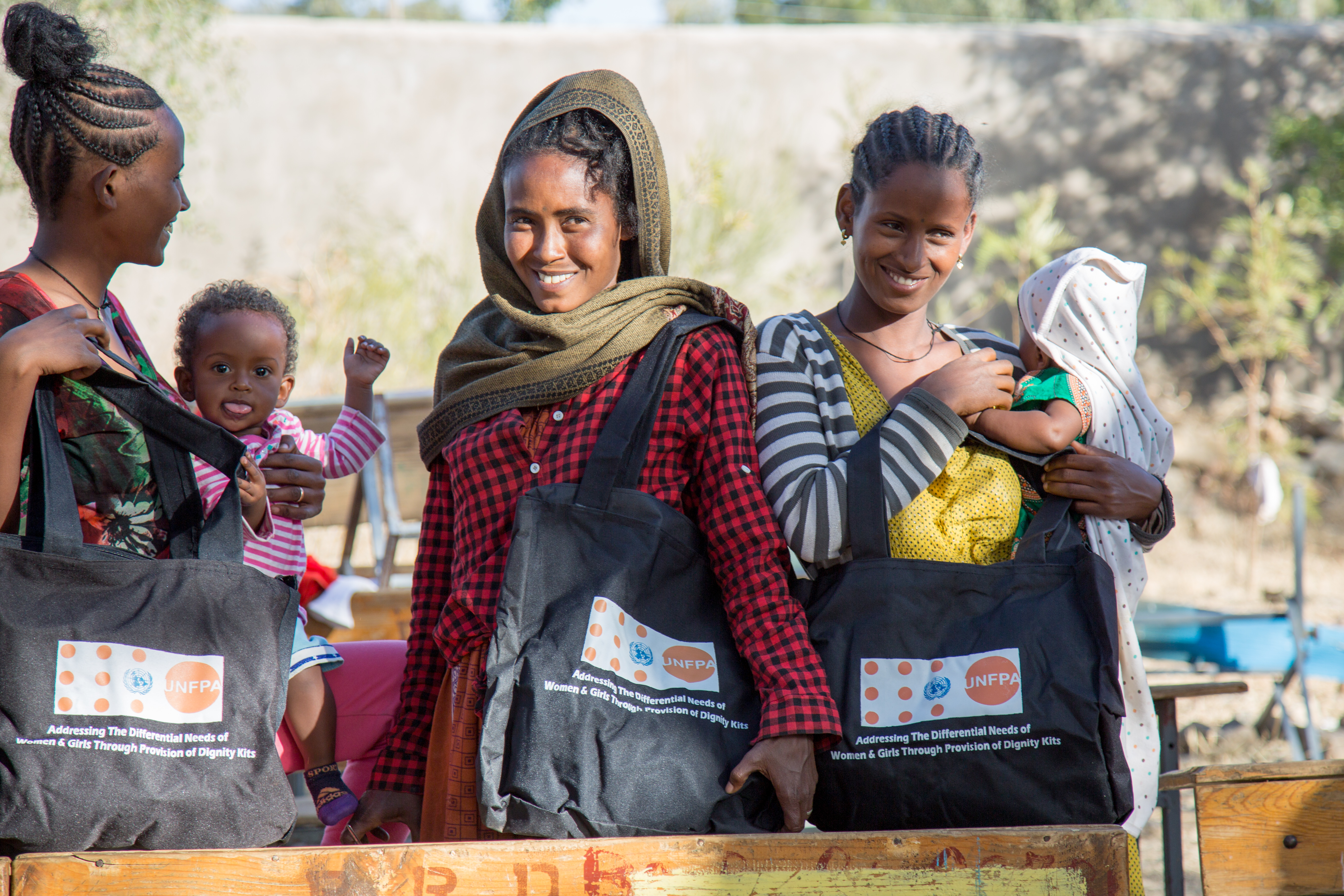 Conflict-affected women with their UNFPA Dignity Kits at Meserete IDP camp in Mekelle, Tigray. Photo by © UNFPA Ethiopia - Paula Seijo.
