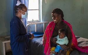 CMMB Health Worker with Mother and Child at Health Facility in Mwandi, Zambia