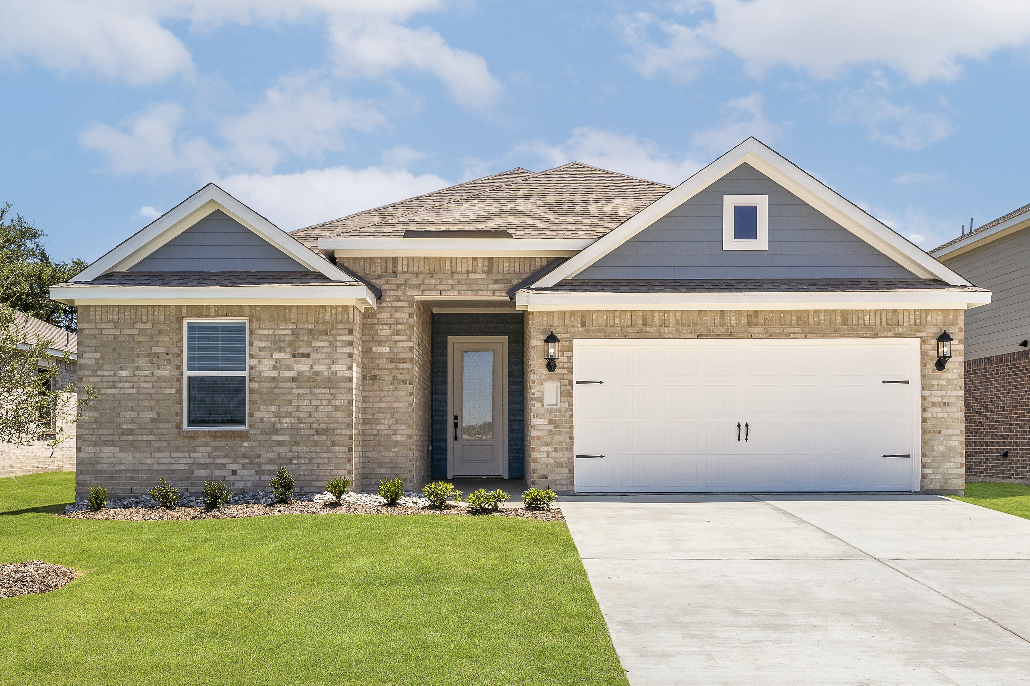 Photo of the one-story Reed plan by LGI Homes in tan brick with a white trim and blue siding accents.