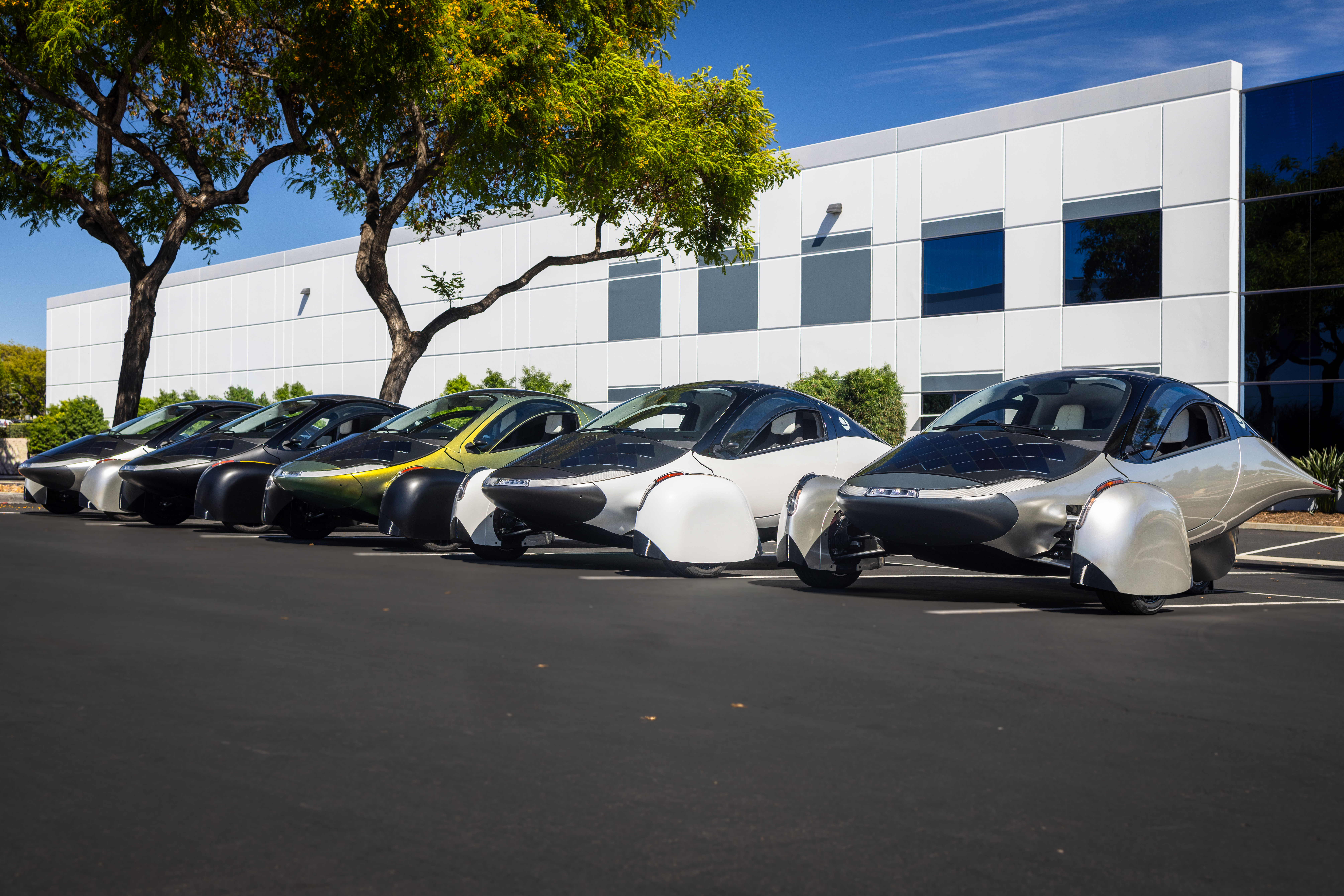 Five Aptera solar electric vehicles parked together after rolling off the validation assembly line.